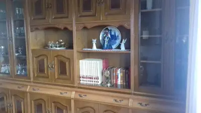 a wooden hutch with books and a plate and books at Villa con piscina en Pantòn Ribeira Sacra Galicia Ideal para familias in Pantón