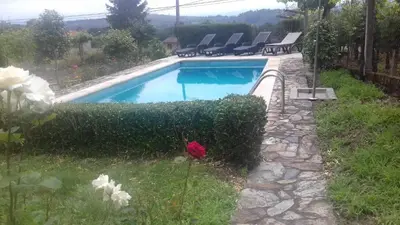 a swimming pool with chairs in a yard at Villa con piscina en Pantòn Ribeira Sacra Galicia Ideal para familias in Pantón