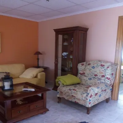 a living room with a couch and a chair at Vivienda de Uso Turístico Carballo Blanco 2 in Barral