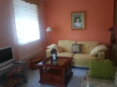 a living room with a couch and a table at Vivienda de Uso Turístico Carballo Blanco 2 in Barral