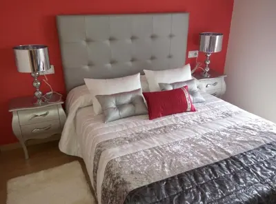 a bedroom with a large bed with two night stands at Vivienda de Uso Turístico Carballo Blanco 1 in Barral