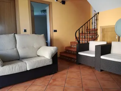 a living room with a couch and two chairs at Vivienda de Uso Turístico Carballo Blanco 1 in Barral