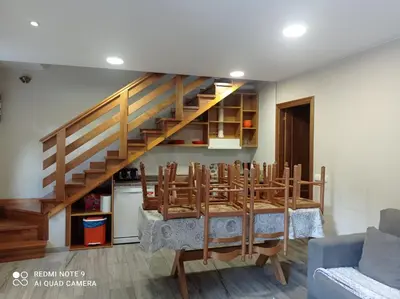 a dining room with a table and a staircase at Casa Rural Las Mestas in Cangas del Narcea