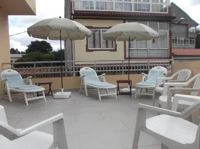 a group of chairs and umbrellas on a patio at O Cabalo Verde in Palas de Rei