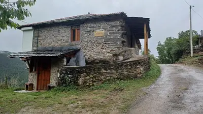 an old stone house on a dirt road at A Palleira in Castro Caldelas