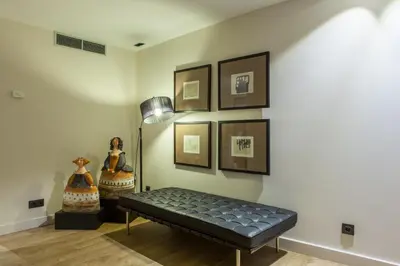 a room with a bench and pictures on the wall at Hotel San Miguel in Santiago de Compostela