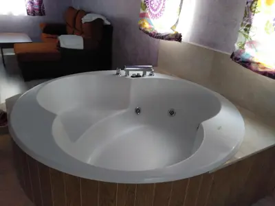 a large white bath tub in a bathroom at Hostal Orly in Camponaraya