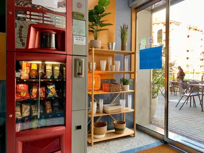 a red refrigerator in a store with food inside at Hostal RIO SELMO in Ponferrada