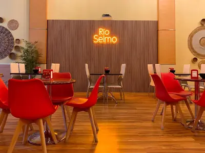 a restaurant with red chairs and tables and a sign that says no sauna at Hostal RIO SELMO in Ponferrada