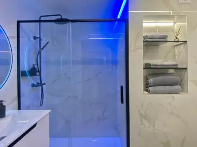 a shower with a glass door in a bathroom at Hostal RIO SELMO in Ponferrada
