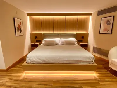 a bedroom with a bed with white sheets and pillows at Hostal RIO SELMO in Ponferrada