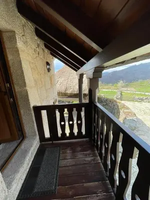 a wooden porch with a view of a mountain at Casa Casoa in Piornedo