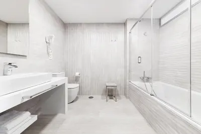 a bathroom with a sink and a toilet and a shower at Apartahotel A Cetárea in Burela de Cabo