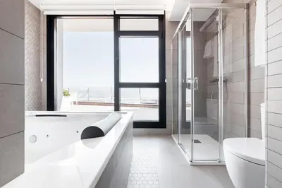 a white bathroom with a tub and a shower at Apartahotel A Cetárea in Burela de Cabo
