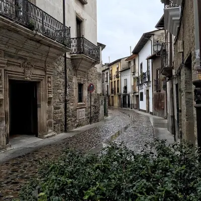 an empty street in an old town with buildings at Las Doñas del Portazgo in Villafranca del Bierzo