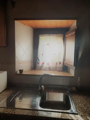 a sink in a kitchen with a window at La Casina de Terobe in Cacabelos