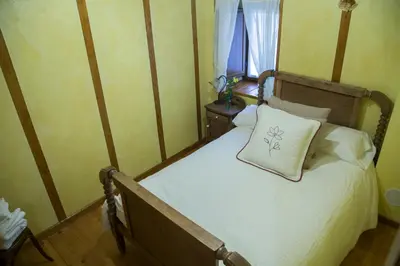 a bedroom with a bed with a pillow on it at La Casina de Terobe in Cacabelos