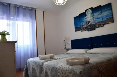 a bedroom with a bed with two towels on it at REGO DA RAÑA APARTMENTS in Arzúa