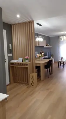 a living room with a table and a dining room at REGO DA RAÑA APARTMENTS in Arzúa