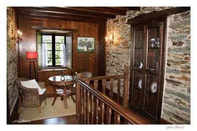 a room with a staircase and a table in a house at Casa Rural Vila Pomar in Ribadeo