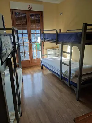 two bunk beds in a room with a wooden floor at La Gallega in Cacabelos