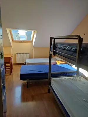 a room with two bunk beds and a window at La Gallega in Cacabelos
