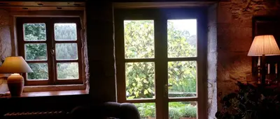 an open window in a room with trees outside at Casa Rural Graña da Acea in Monfero