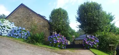 a garden of colorful flowers in front of a building at Casa Rural Graña da Acea in Monfero