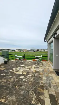 two benches on a patio with a view of a field at Apartamentos Castello in Cartavio