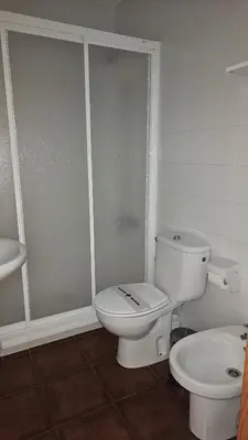 a bathroom with a toilet and a sink at Apartamentos Castello in Cartavio