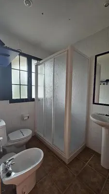 a bathroom with a sink and a toilet and a shower at Apartamentos Castello in Cartavio