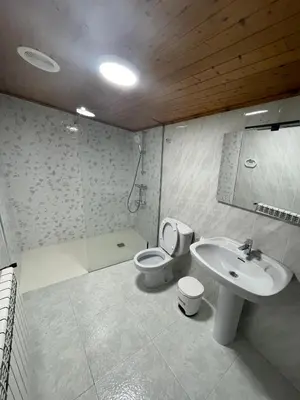 a bathroom with a toilet and a sink at Hotel Victorino in Silleda
