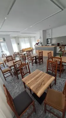 a room filled with wooden tables and chairs at Hotel Victorino in Silleda