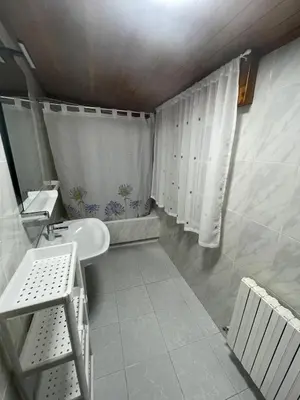 a bathroom with a sink and a shower curtain at Hotel Victorino in Silleda