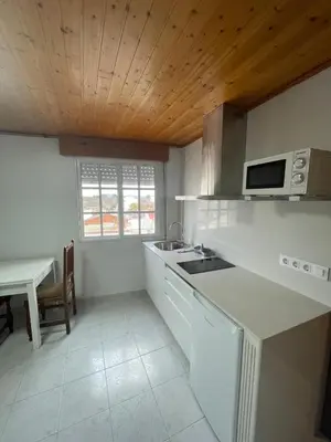 a kitchen with a sink and a microwave at Hotel Victorino in Silleda