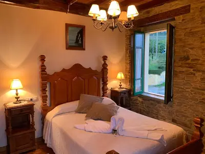 a bedroom with a bed with two towels on it at Casa da Roxa in Foz