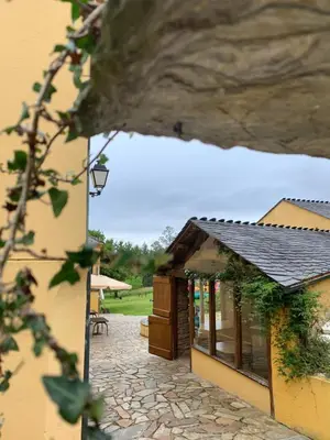 a building with a door and a stone patio at Casa da Roxa in Foz