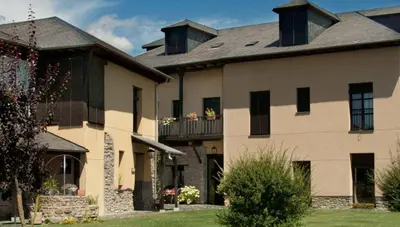 a large house with two balconies on the side of it at El Tiempo Recobrado - Hotel de relax en El Bierzo in Villamartín de la Abadía