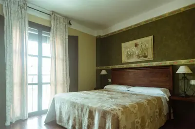 a bedroom with a large bed and a window at El Tiempo Recobrado - Hotel de relax en El Bierzo in Villamartín de la Abadía