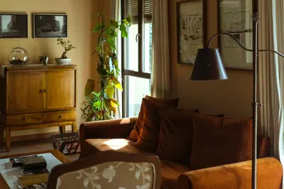 a living room with a couch and a lamp at El Tiempo Recobrado - Hotel de relax en El Bierzo in Villamartín de la Abadía