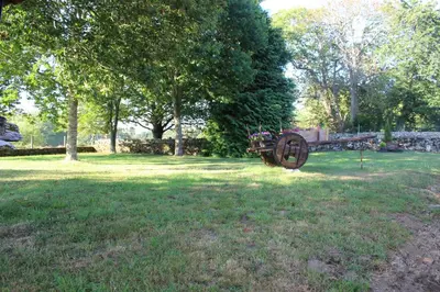 an old cannon sitting in the grass in a field at Casa Solveira in Piñeiro