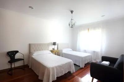 a hotel room with two beds and a couch at A Quinta de Lapido in Ortoño