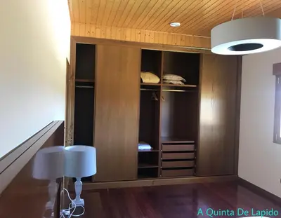 a room with a staircase with a wooden closet at A Quinta de Lapido in Ortoño
