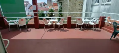 a balcony with a table and chairs on a balcony at Pensión Casa Douro in Santiago de Compostela