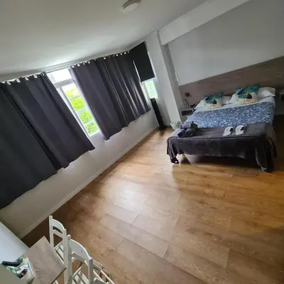 a bedroom with a bed and a wooden floor at Pensión Casa Douro in Santiago de Compostela