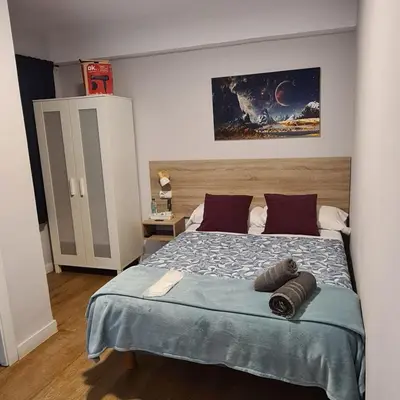 a bedroom with a bed with two pillows on it at Pensión Casa Douro in Santiago de Compostela