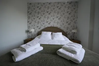 a bedroom with a bed with towels on it at Vivienda Uso Turístico Prado novo in Suarbol