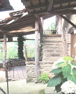 a stone building with a bench on a patio at Casa do Solpor in La Teijeira