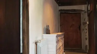 a room with a white radiator and a door at Casa do Solpor in La Teijeira