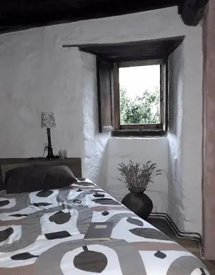 a bedroom with a bed and a window at Casa do Solpor in La Teijeira